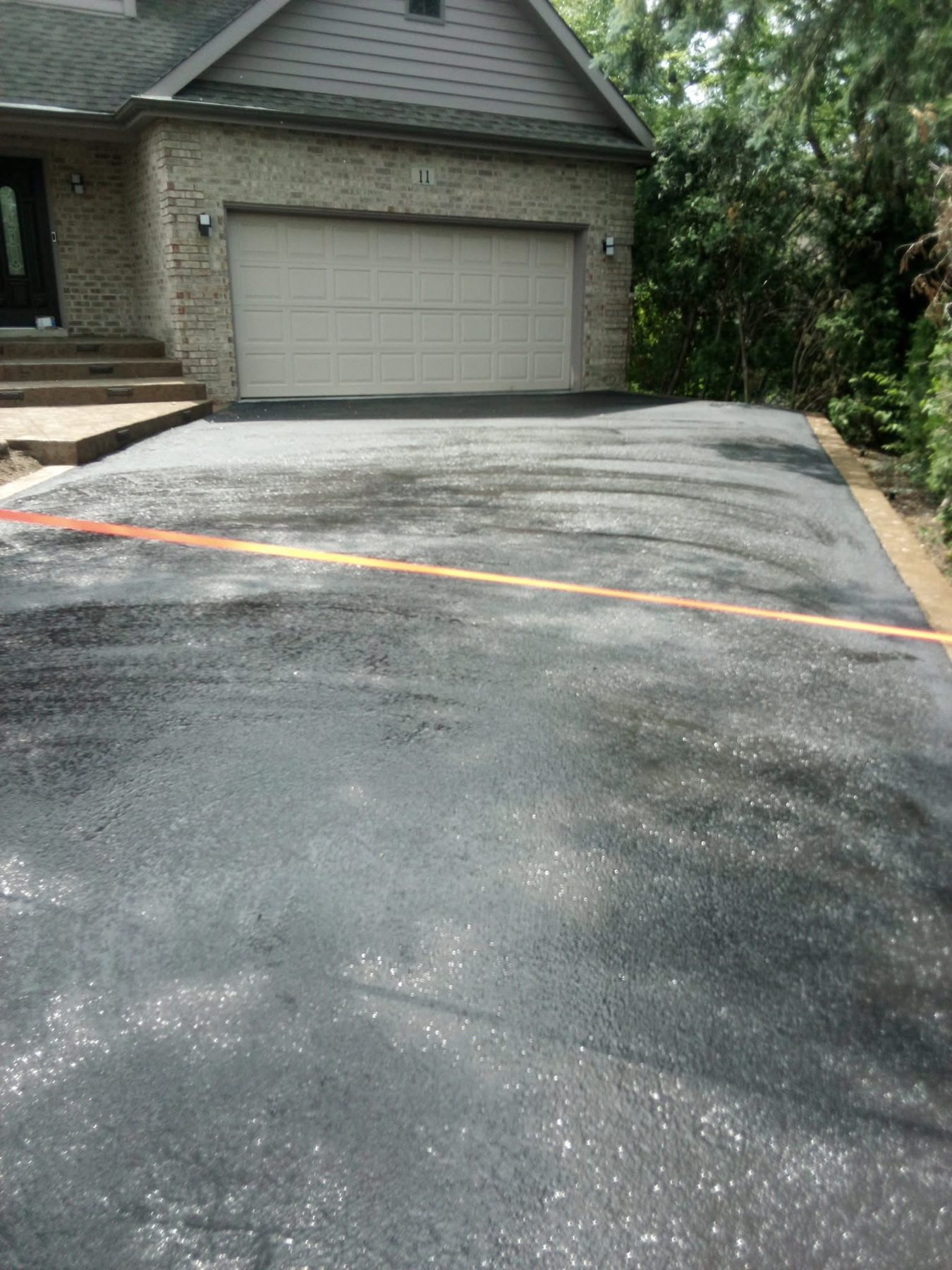 Residential driveway sealcoating
